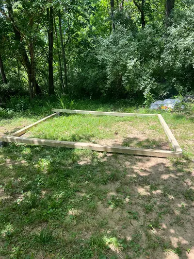 Wood frame staked out for a new paver patio